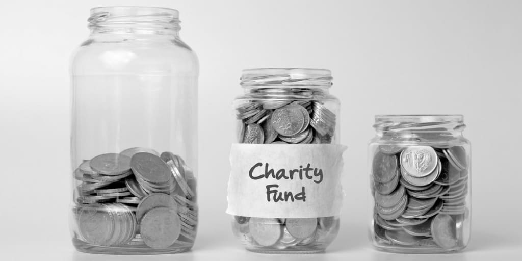 3 clear glass jars filled with coins