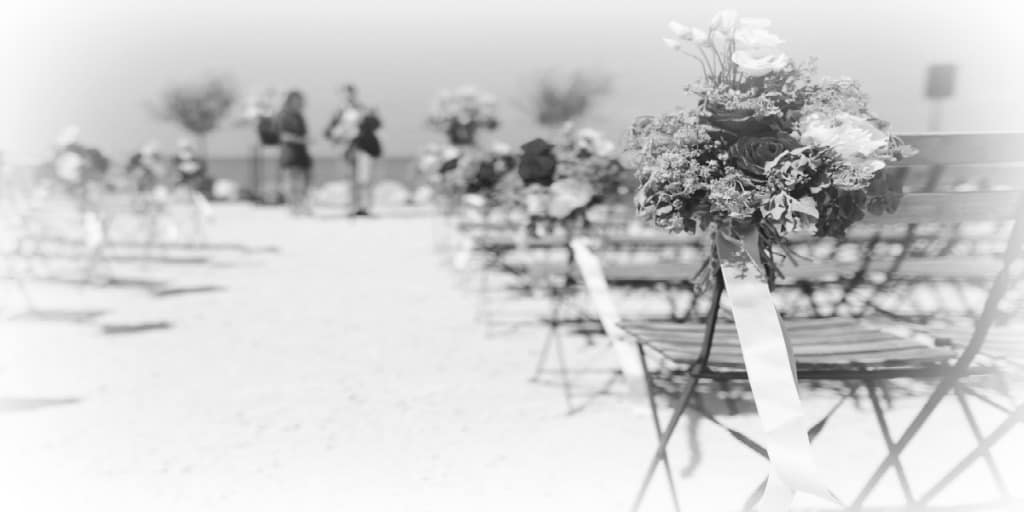 black and white image of a beach set up for a wedding