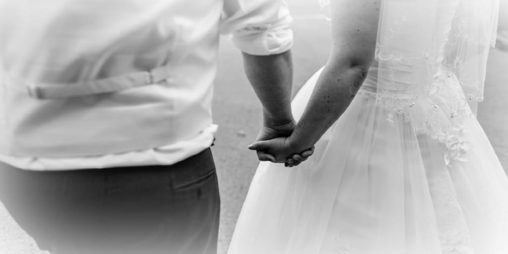 new bride and groom holding hands