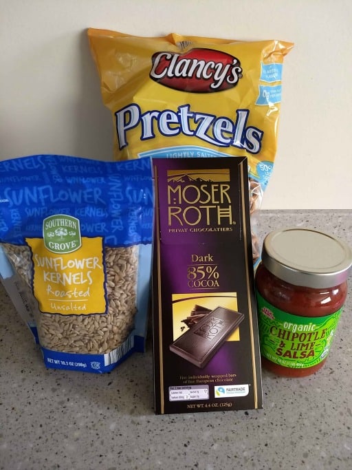 aldi food products, mini pretzels, chocolate bar, salsa, and sunflower seeds