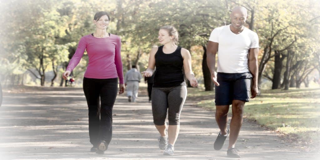 Three people walking in a park, getting some exercise