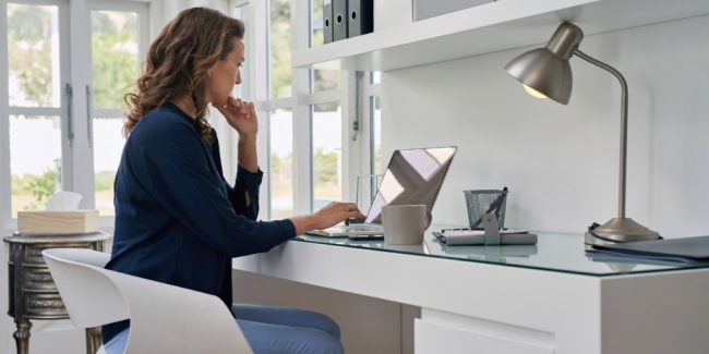 businesswoman entrepreneur working on laptop from home office space