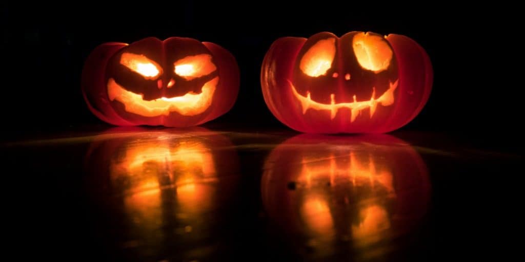 two lit carved pumpkins