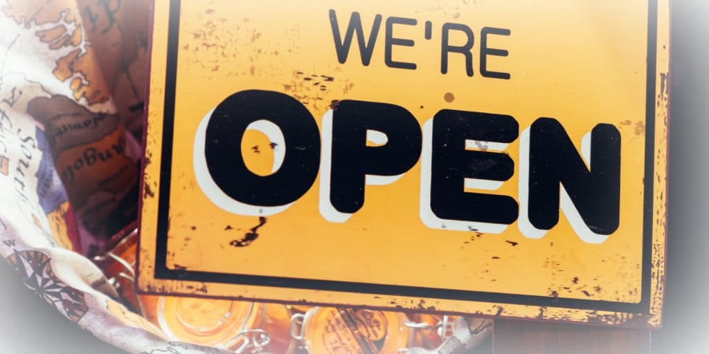 yellow and black open for business sign