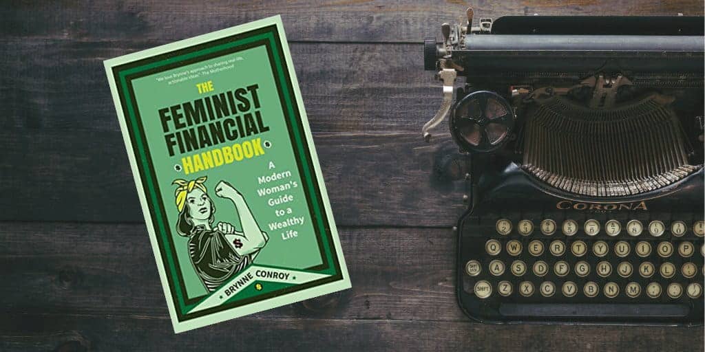 feminist financial handbook cover photo next to old typewriter