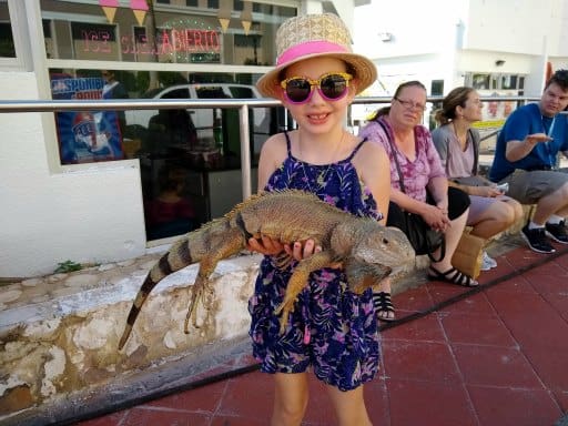 inspiring money story Faith - holding a large iguana