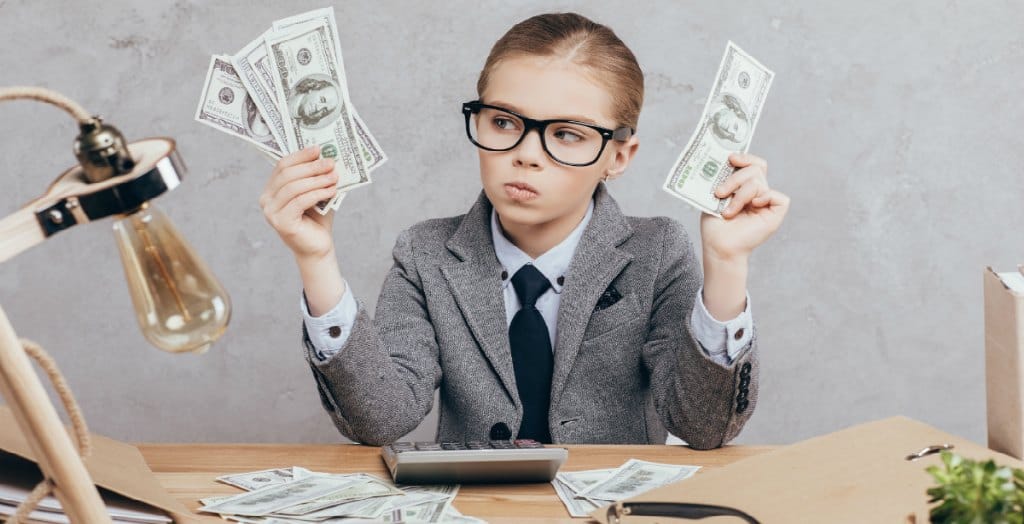 young girl looking at cash money in her hand wondering if joining a credit union would be best for her money