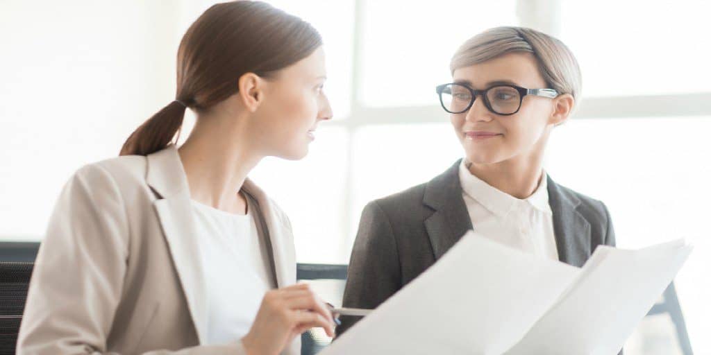 two female financial professionals conversing