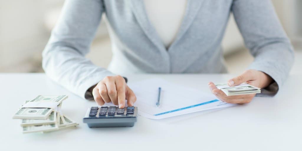 women calculating potential returns on tax lien investing