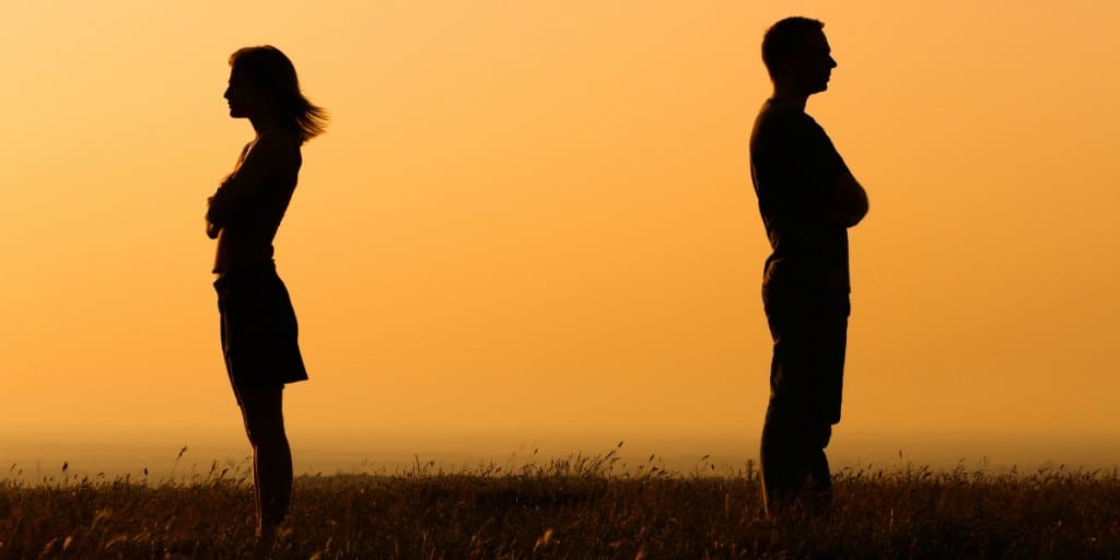 silhouette of a couple with backs to each other