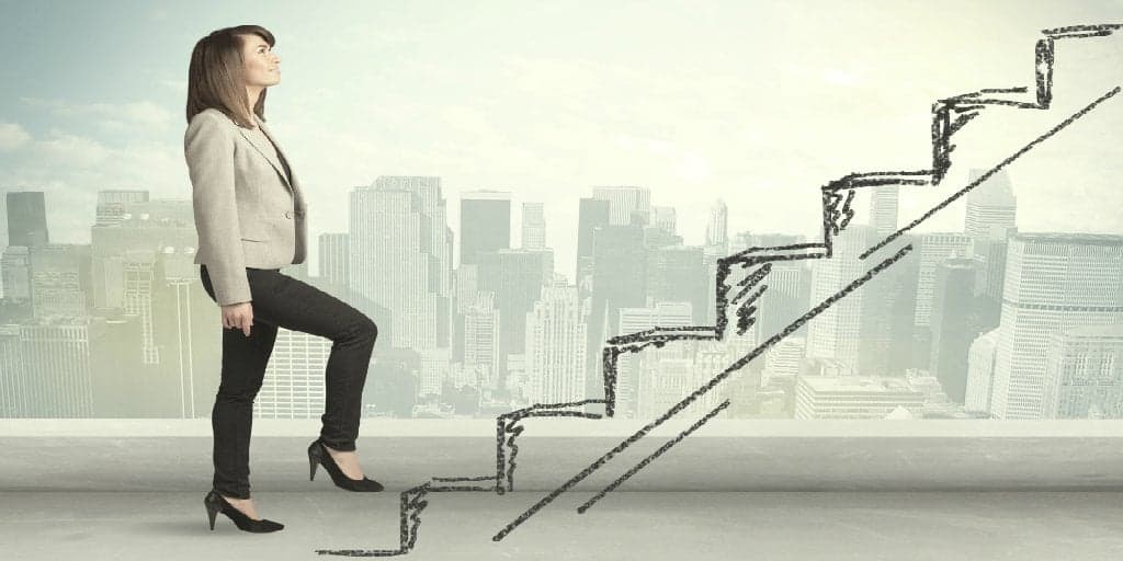 woman climbing a hand drawn staircase representing a career path