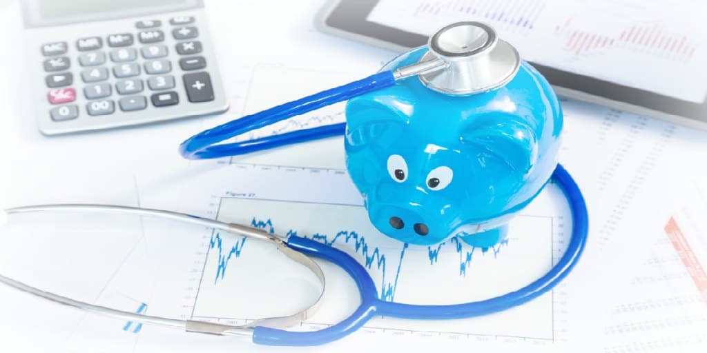 Stethoscope and piggy bank for financial health concept