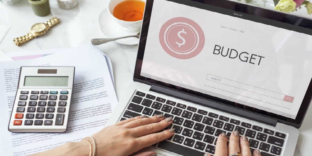 women working on a budget on her laptop