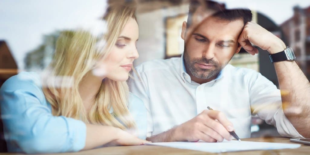 couple looking over a postnuptial agreement