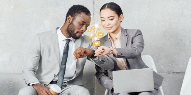 couple comparing smart technology they are wearing on their wrists