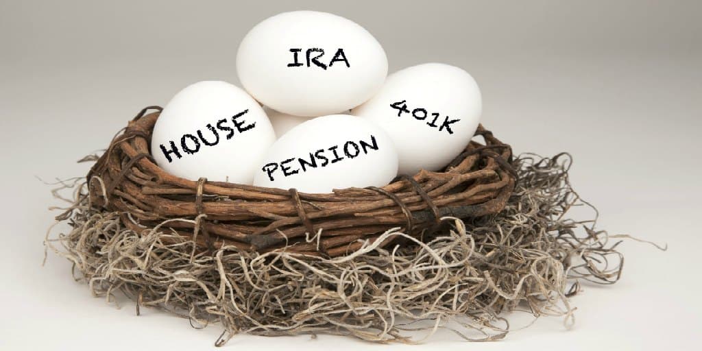 a nest full of eggs with retirement and financial words written on them IRA Pension 401k