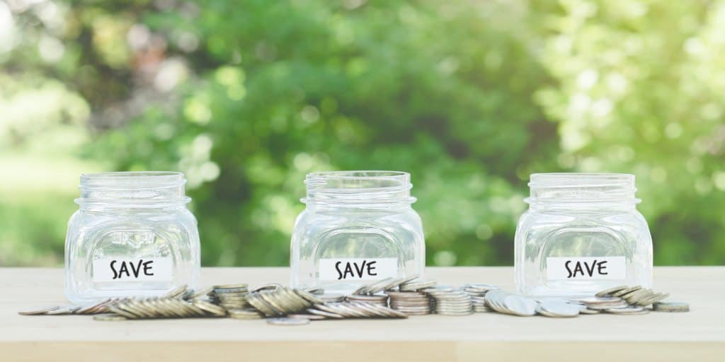 three glass jars to save money in sinking fund accounts