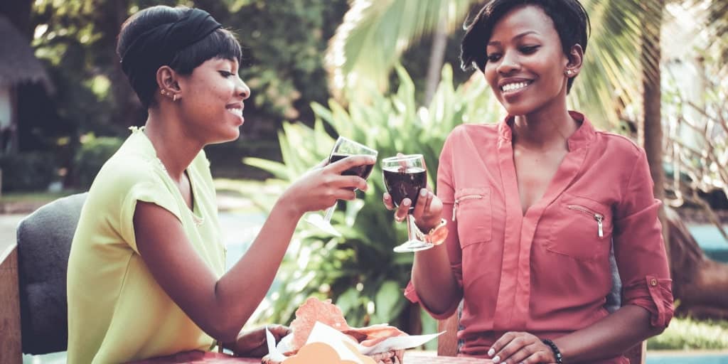 two women toasting their friendship over wine