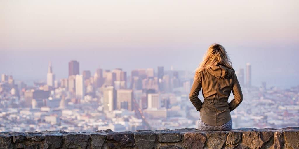 woman looking at a vast city landscape from a view above