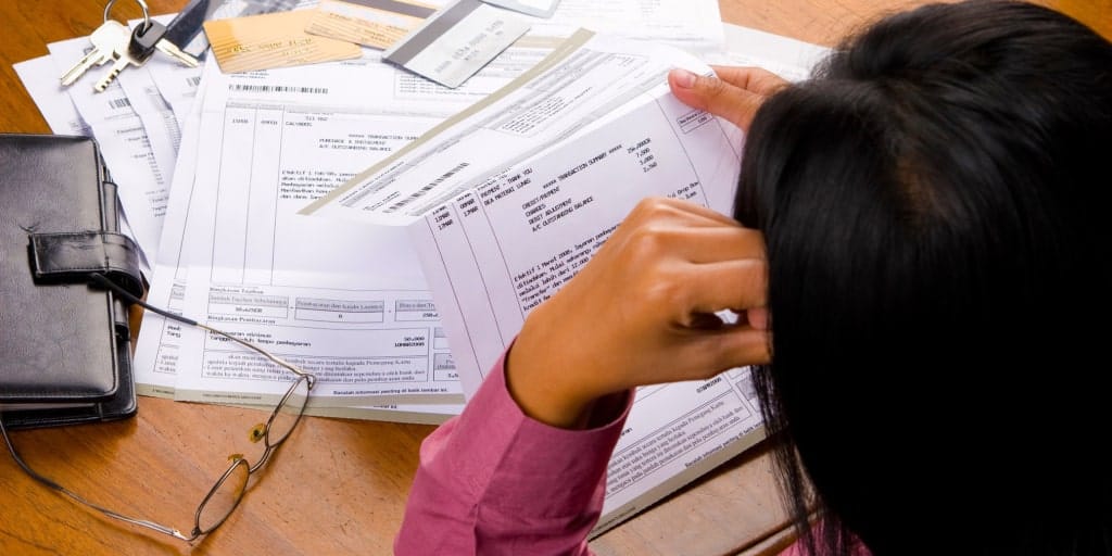 women looking at past due bills and debt collection letters