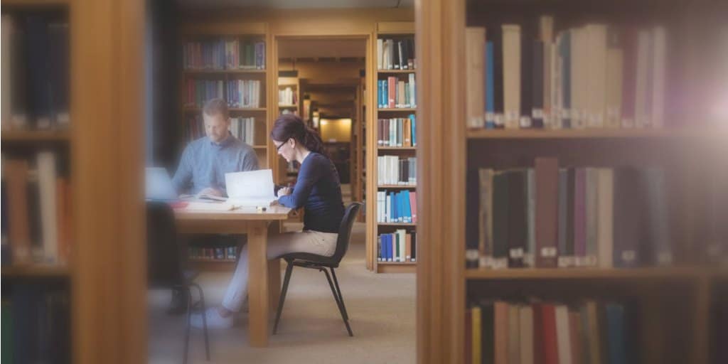 couple working at table in public library