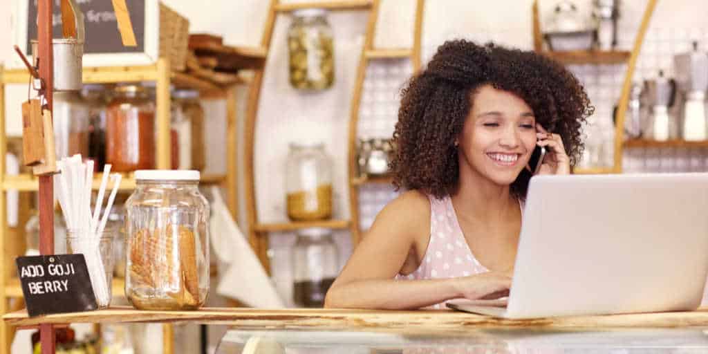 women working part time at a coffee shope while growing her business