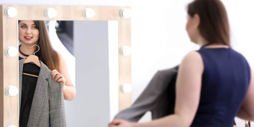 woman trying on clothes for work wardrobe