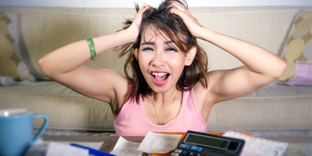 young woman exhibiting stress over her debt