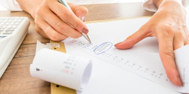 woman reviewing a paper receipt