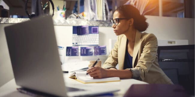 young black women working on her professional development at a desk in her office