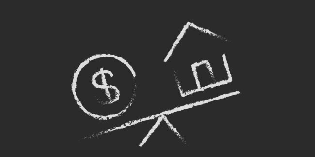 chalk drawn money symbol and house on a tipping scale depicting the mistake of paying to much money when buying a home