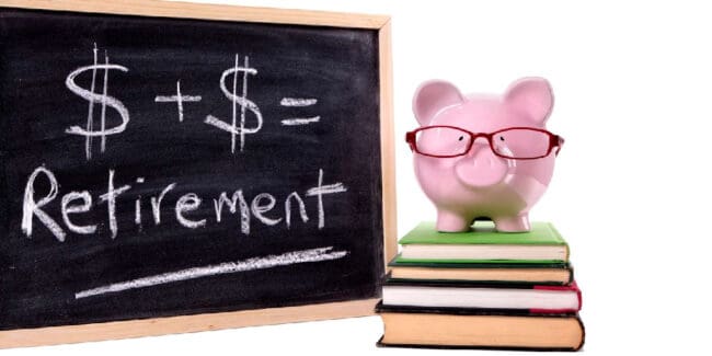 piggy bank sitting on a stack of books, chalkboard with retirement number calculation written on it