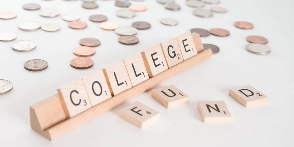 college spelled out with scrabble letter tiles and coins spread out on table top