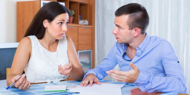 Family couple with money problems making shopping list indoors