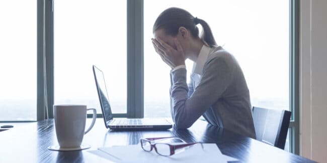 cpa in her office stressed over her massive debt