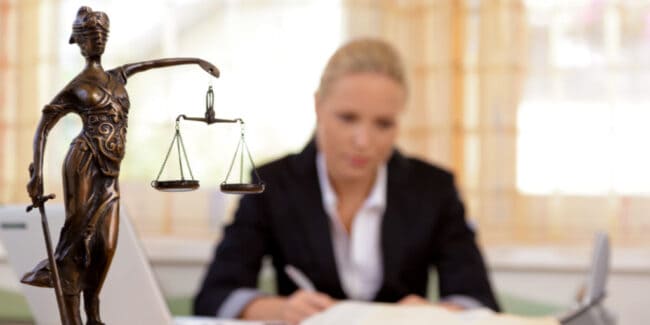 a young lawyer is sitting at her desk in the office