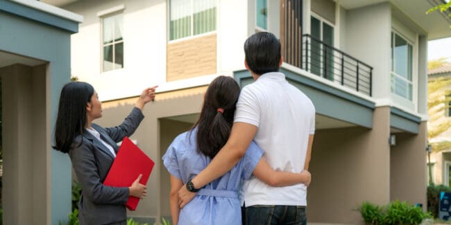 real estate agent showing housing to a couple