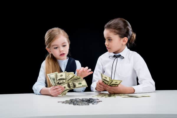 young girls playing with money