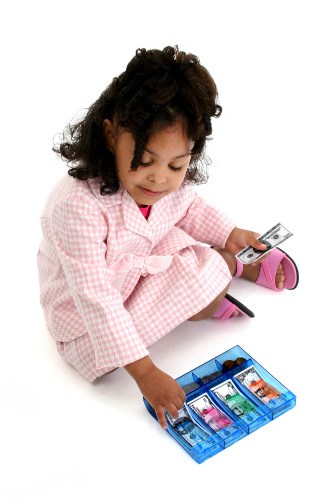 Little girl playing business woman with pink and white suit, pink sandals, and money.