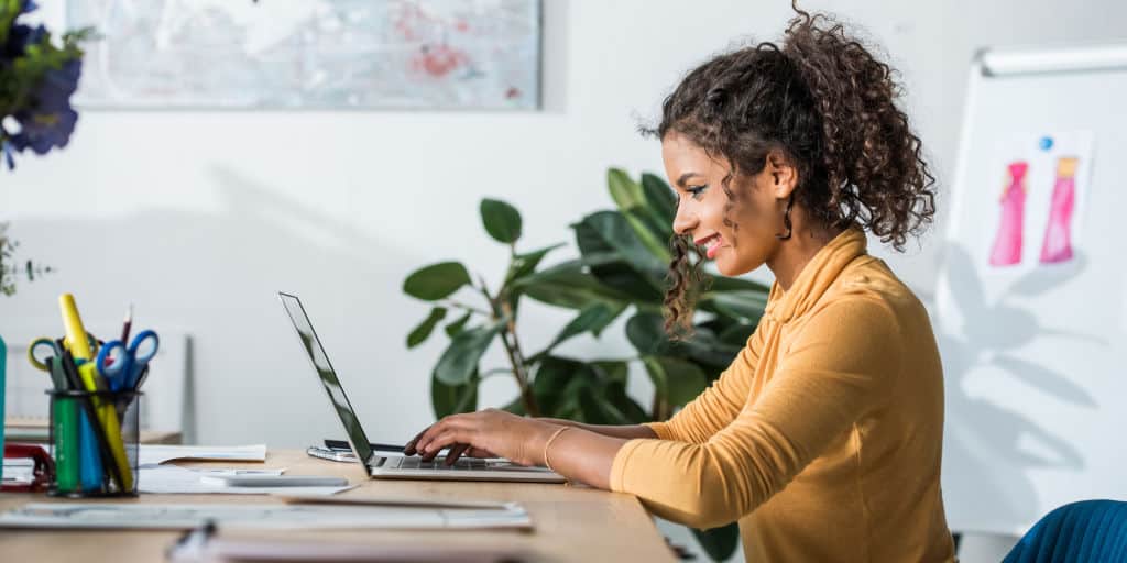 young woman working at her desk on her laptop