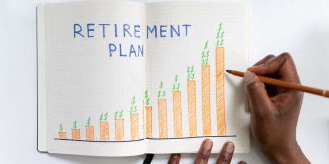 african american woman drawing graph depicting retirement savings progress