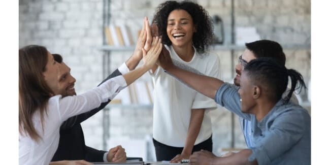 loyal employees high fiving each other