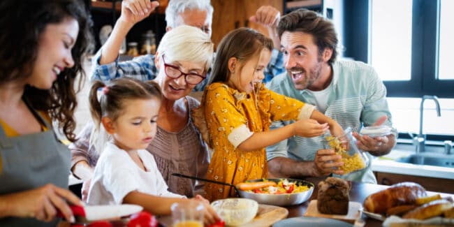 three generations cooking in kitchen together