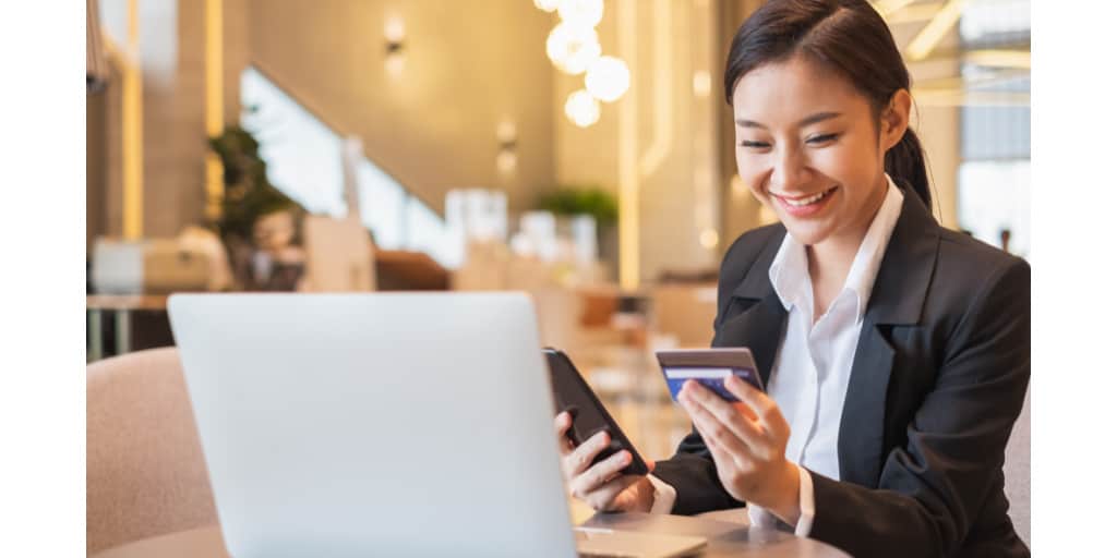 young woman using business credit card