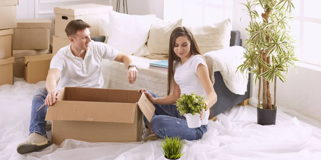 young couple unpacking boxes in a new home