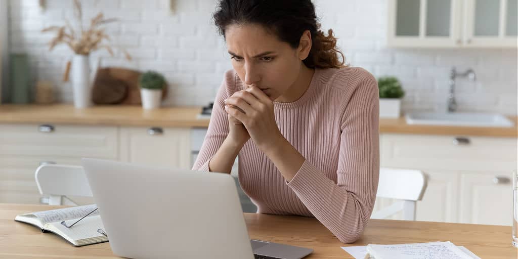 woman in kitchen contemplating retirement financial plans