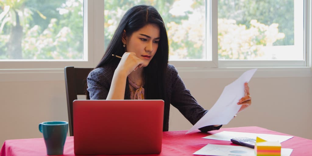 woman reviewing stock information and financial reports