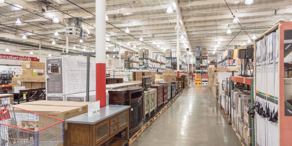 Inside Costco Wholesale Club store showing boxes from floor to ceiling.