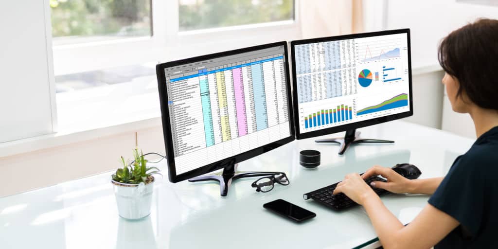 registered financial advisor reviewing spreadsheets and charts on computer