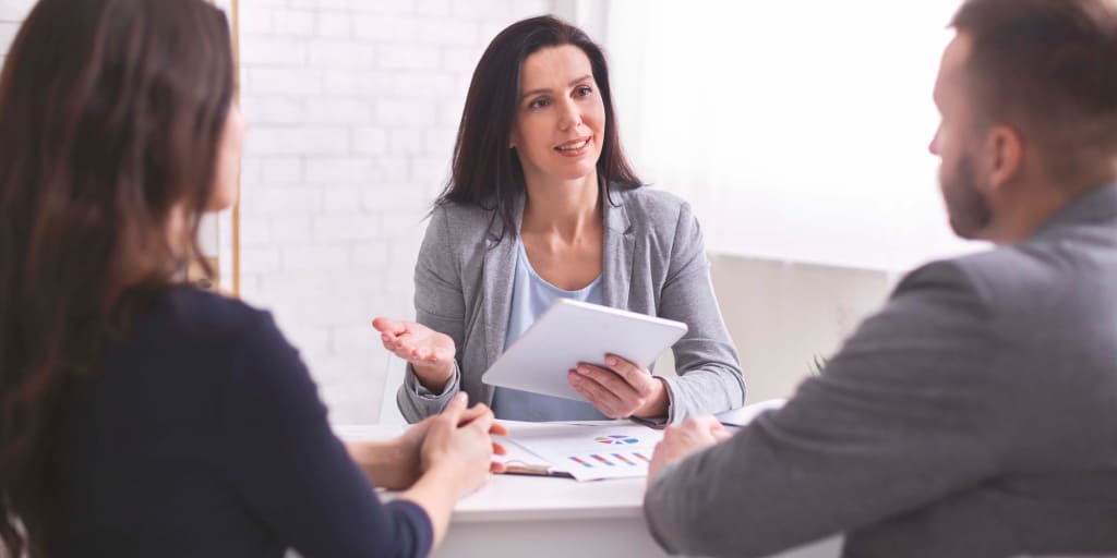 female CFP meeting with clients, husband and wife 